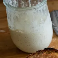 A jar of bubbly sourdough starter